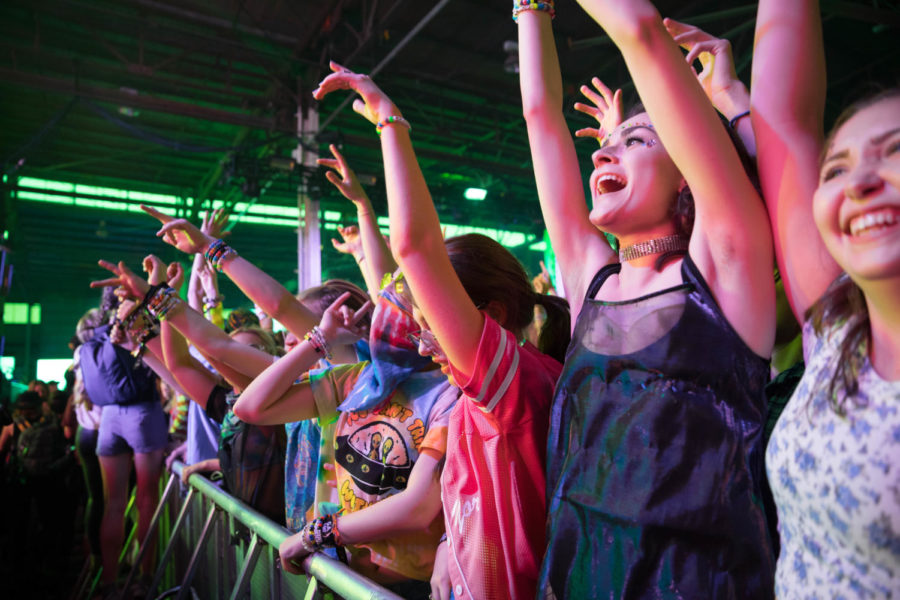 Festival goers dance during a live performance at BUKU Music + Art Project in 2018. Behind the scenes of the festival were numerous employees – many of them students – working to keep things running smoothly. ANGELO IMBRAGUGLIO / The Maroon. Photo credit: Angelo Imbraguglio