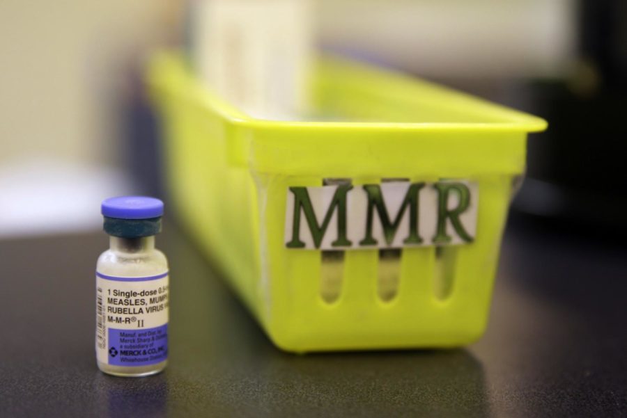 FILE - This Feb. 6, 2015, file photo shows a measles, mumps and rubella vaccine on a countertop at a pediatrics clinic in Greenbrae, Calif. Hundreds of opponents of mandatory vaccines are opposing a California proposal to give state public health officials instead of local doctors the power to decide which children can skip their shots before attending school. They plan to pack the first legislative hearing Wednesday, April 24, 2019 on a bill that proponents say would stem bogus exemptions granted in many cases by doctors who are paid to excuse students from vaccinations. Supporters say pockets of unvaccinated students help to spread measles. (AP Photo/Eric Risberg, File)