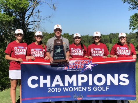 2019 Loyola golfers and head coach Drew Goff pose with their championship banner and trophy after their conference win on April 10, 2019. Photo credit: Jose Bedoya
