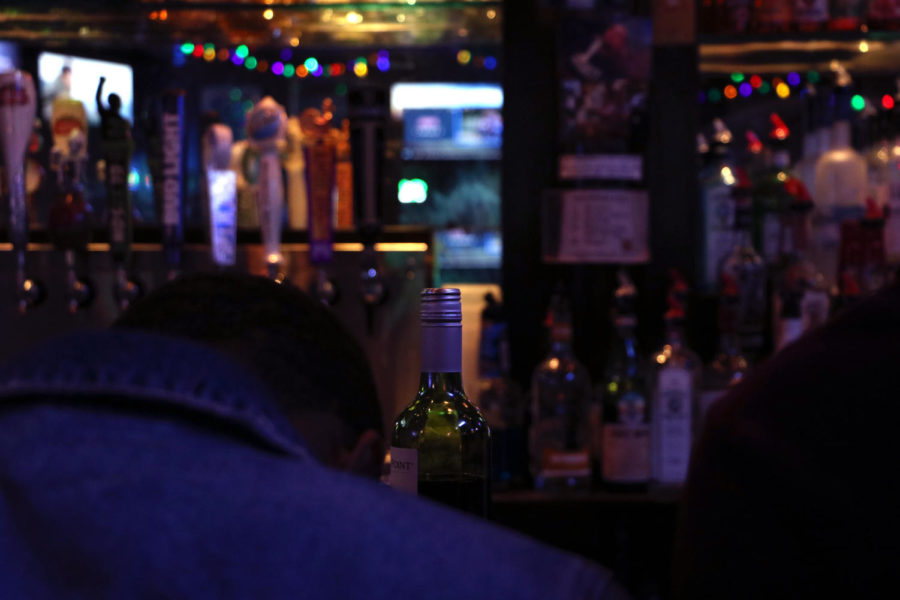 A patron sits at a college bar. Many college bars have a series of health code violations. Photo credit: Hannah Renton