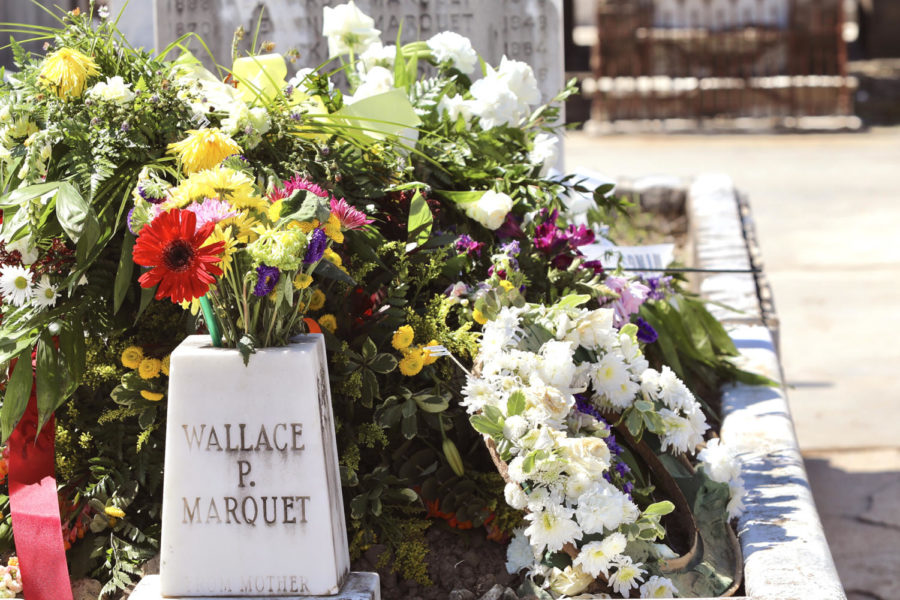 A large assortment of flowers are laid at the grave of Wallace Marquet.  Several graves had flowers to help remember passed loved ones. ANDRES FUENTES/The Maroon.