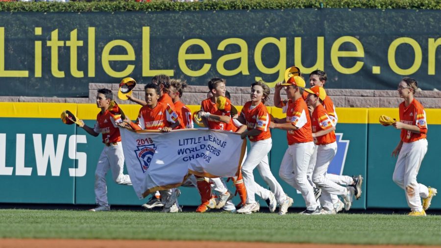 River Ridge, Louisiana's Alton Shorts, River Ridge, Louisiana's Stan Wiltz, Ryder Planchard and Derek DeLatte carry the championship banner around the stadium as they celebrate the 8-0 win against Curacao in the Little League World Series Championship game in South Williamsport, Pa., Sunday, Aug. 25, 2019. (AP Photo/Tom E. Puskar)