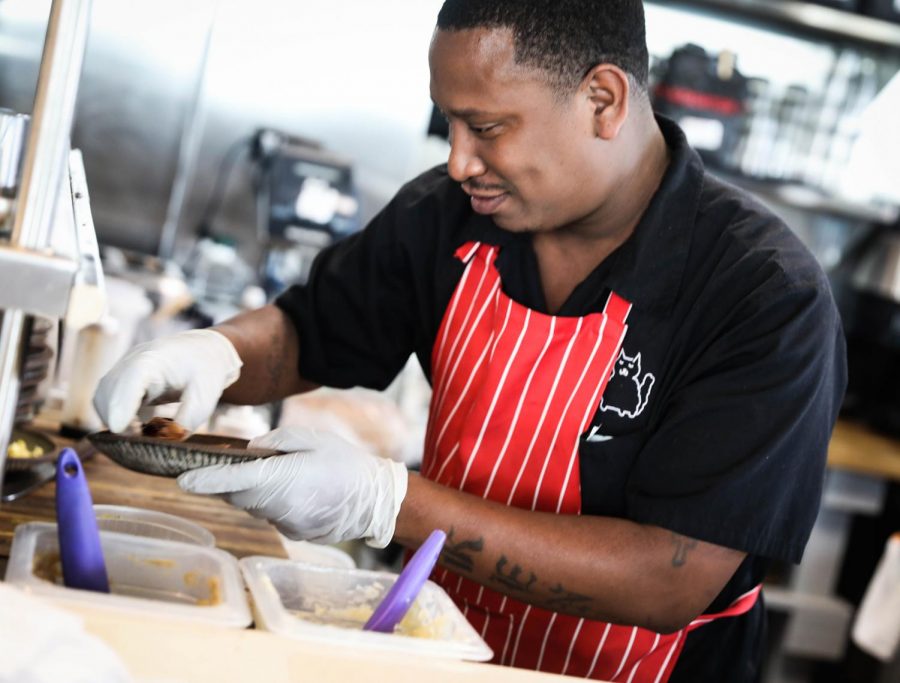 A Bearcat Cafe line cook prepares a meal. Bearcat Cafe serves American, Cajun and Creole food. Photo credit: Michael Bauer