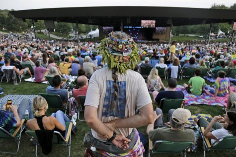 Music fans listen to the band Blood, Sweat and Tears play at a concert celebrating the 50th anniversary of Woodstock in Bethel, N.Y., Friday, Aug. 16, 2019. Bethel Woods Center for the Arts is hosting a series of events Thursday through Sunday at the bucolic 1969 concert site, 80 miles (130 kilometers) northwest of New York City.