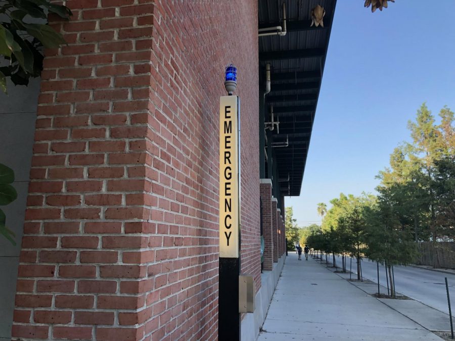 An emergency pole stands on Tulane's campus. Tulane police officers opened fire today on a former contract employee wanted for indecent exposure and trespassing. Photo credit: Rae Walberg