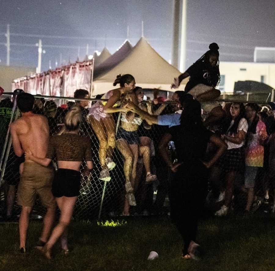 In this Saturday, Sept. 7, 2019 photo, Festivalgoers try to escape the crowd during Lil Waynes fifth annual Lil WeezyAna Fest at the UNO Lakefront Arena grounds in New Orleans. A crowd stampede injured several people attending a New Orleans festival organized by rapper Lil Wayne. Sophia Germer/The Advocate via AP
