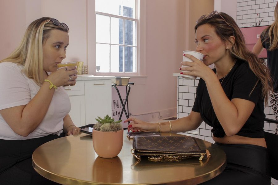 Loyola students Lily Glennon and Tess Rowland enjoying their drinks on Aug. 17, 2019. Drink Beauty is a cashless business, so all order transactions are made digitally. Photo credit: Caitlyn Reisgen