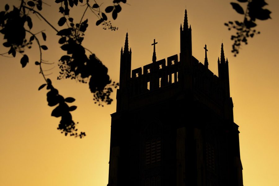 The sun sets on Holy Name of Jesus Church on Sept. 24, 2019. Due to the COVID-19 pandemic, churches all around New Orleans have shut their doors and cancelled mass, leaving student-musicians who play during the services out of work. Photo credit: Michael Bauer