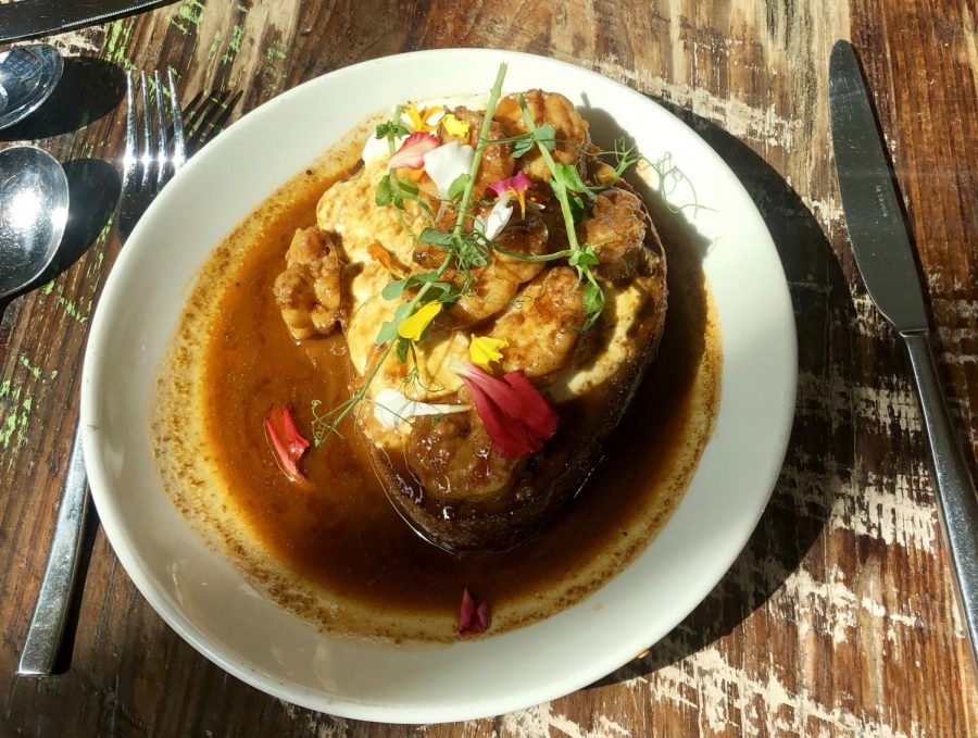 Barbecue Shrimp Toast is served at Willa Jean. The dish featured a barbecue shrimp and edible flowers. Photo credit: Tess Rowland