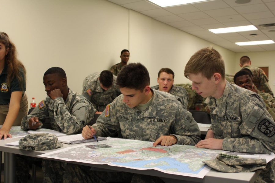 Ethan Giddens, psychological science freshman, plots points on a map in the land navigation lab on Tulanes campus. College students throughout the city travel to Tulane to participate in ROTC.