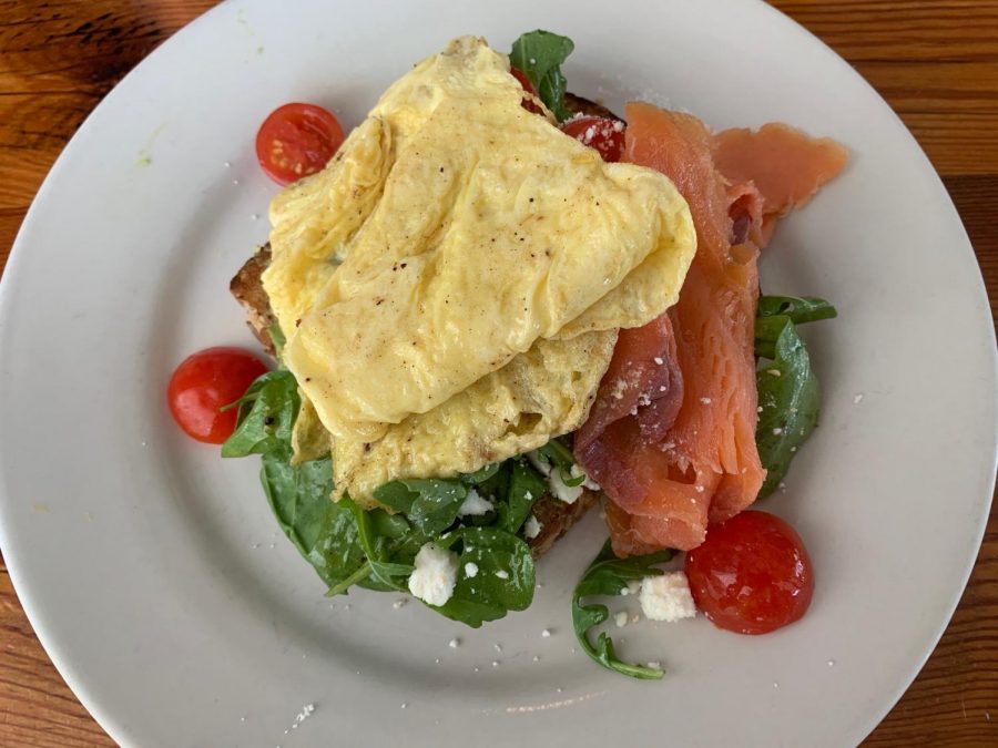 Satsumas omelet with avocado toast and smoked salmon with tomatoes and spinach sits on a plate on a Sunday morning. This is a go-to for many restaurant patrons. Photo credit: Valerie Cronenbold