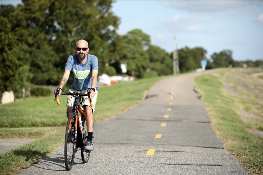 Frankie Avila rides his bike on the levee in Rivertown, Kenner. Photo Credit: Andres Fuentes