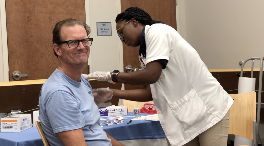 Joni Mosely, Walgreens pharmacist, administers a flu shot at Nora Navra library on Oct. 4. Walgreens is teaming up with New Orleans Public Libraries to provide free flu shots. Photo credit: Sam Lucio