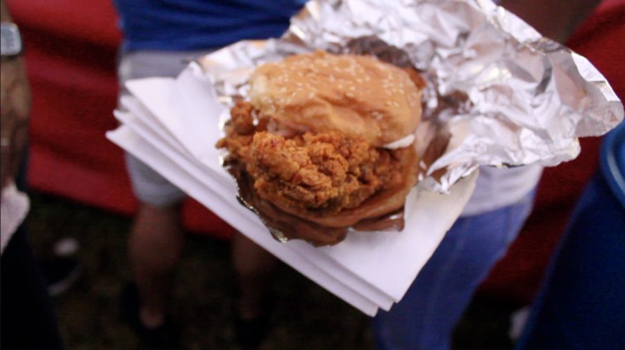 Customers pose with Southern's fried chicken "Otis" sandwich. The chicken wooed festival goers with its sliding scale of spice options,. Photo credit: Gabriella Killett