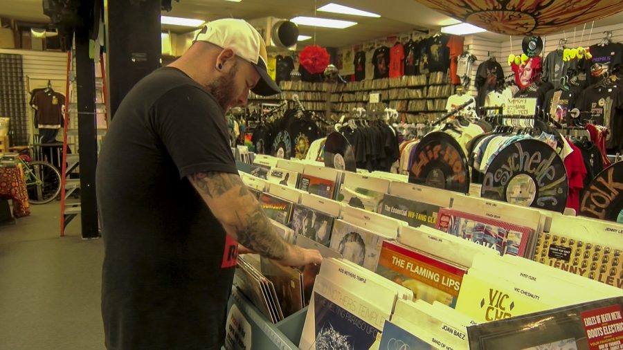 A+Mushroom+employee+shuffles+through+a+section+of+vinyl+records.+Mushroom+has+been+selling+vinyl+records+since+1969.+