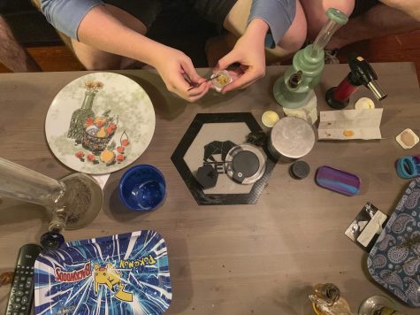 A college student uses a metal nail to break off a piece of wax concentrate before inhaling its vapor to get high Sept. 10. Earwax-like marijuana concentrates have been known to elicit extreme highs and, sometimes, psychotic behavior, according to Special Agent Randy Ladd of the Denver Division of the DEA.