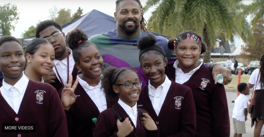 Cam Jordan posing with students. photo credit: Tess Rowland