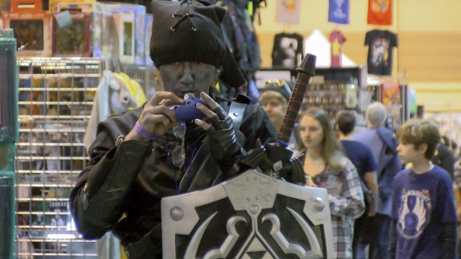A cosplayer dressed up as Shadow Link from the video game The Legend of Zelda plays the ocarina at Big Easy Con on Nov. 2. The ocarina is an important item in the video game series. Photo credit: Cody Downey