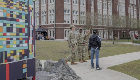 A commercial production filming on campus redesigns a Loyola sign for their set on Nov. 8 2019. The production sparked controversy when students and faculty reported hearing simulated gunshots. Hannah Renton/The Maroon. Photo credit: Hannah Renton
