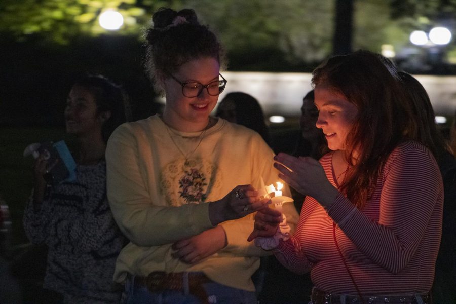Sophomore psychology majors Melissa Berner and Ivy Fitzgerald light candles during the Take Back the Night march on Oct. 24. The march took place down St Charles Avenue and Broadway Street. to stand in solidarity with sexual assault survivors and victims of gender violence. 