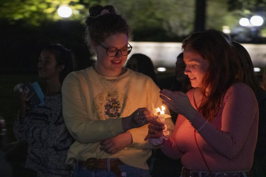 Sophomore+psychology+majors+Melissa+Berner+and+Ivy+Fitzgerald+light+candles+during+the+Take+Back+the+Night+march+on+Oct.+24.+The+march+took+place+down+St+Charles+Avenue+and+Broadway+Street.+to+stand+in+solidarity+with+sexual+assault+survivors+and+victims+of+gender+violence.+