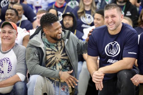 Usher and Tim Tebow pose ahead of their volunteer work at Einstein Charter on December 31, 2019. Photo credit: Rhon Ridgeway