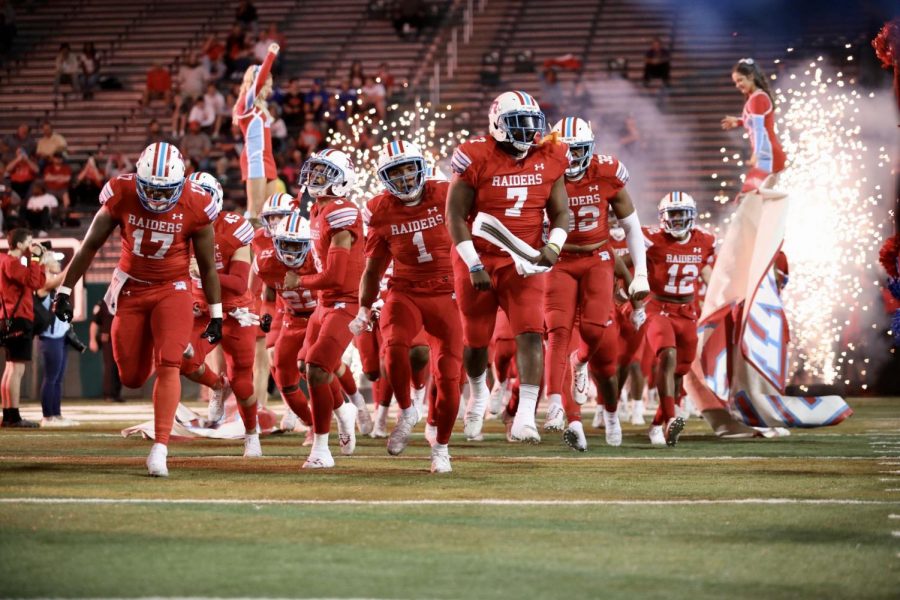 The Archbisop Rummel High School football team rushes onto Yulman Stadium to play Catholic High for the LHSAA Division 1 state championship on Dec. 6, 2019. Photo credit: Andres Fuentes