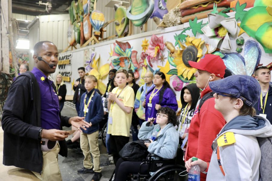 A guide for Mardi Gras World talks with visitors from the Sunshine Kids Foundation. The children visited Mardi Gras World as a part of their visit to New Orleans.