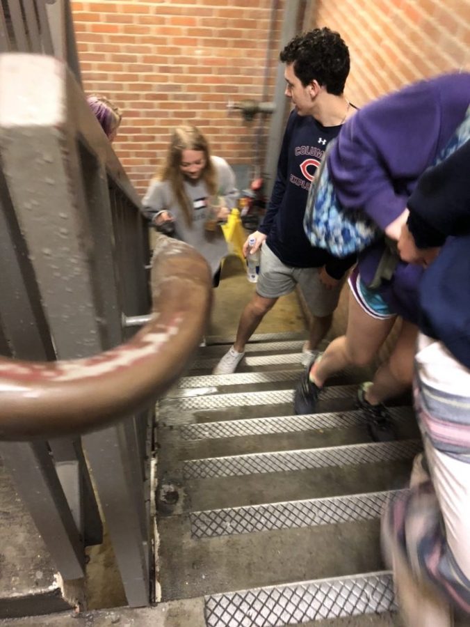 Students evacuate Biever Hall on Feb. 12 after a sprinkler went off, flooding the sixth floor of the residence hall.