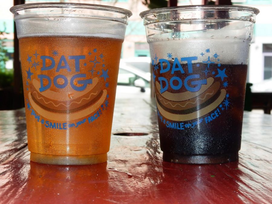 A beer and soda sit on a table at Dat Dog. Dat Dog has two locations Uptown. Photo credit: Shadera Moore