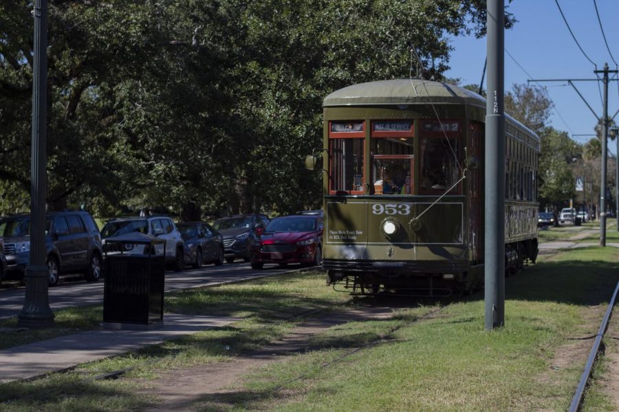 A not in service streetcar speeds by on St Charles Avenue. Loyolas Department of Student Life and Ministry is now providing jazzy passes for the streetcar. Photo credit: Cristian Orellana