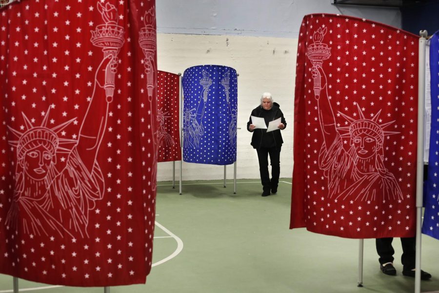 A voter checks her ballots after coming out of a booth while voting in the primary election, Tuesday, March 3, 2020, in Mechanic Falls, Maine. Voters in Louisiana will have to wait until June to cast their primary ballots, as the state delayed its primaries in the wake of the COVID-19 outbreak (AP Photo/Robert F. Bukaty)