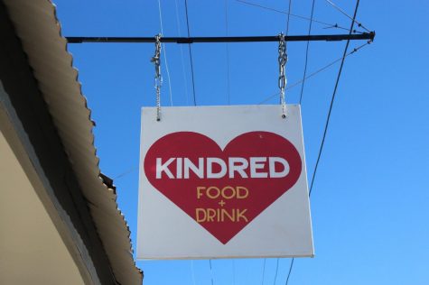 A business sign for Kindred, a New Orleans restaurant, hangs outside