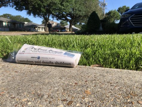 An issue of The Times-Picayune | The New Orleans Advocate sits on a subscriber's driveway May 7. Due to COVID-19, local journalists have had their hours cut. The Advocate company put 10% of its staff on a “permanent furlough,” while the rest of the organization’s staff members have had their hours cut for payroll savings, working four-day work weeks once every pay period, according to newsroom leaders. Photo credit: Michael Giusti