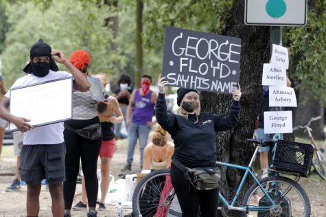 A protester holds a sign that reads