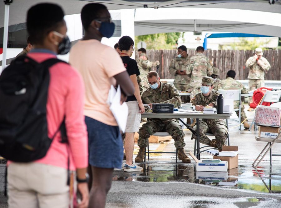 Members of the Louisiana National Guard sign students in for free on-campus testing in the parking lot of Mercy Hall Aug. 31. Photo credit: Michael Bauer