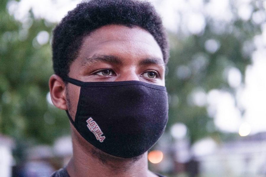 Omari Caldwell poses while wearing his university-provided mask on Friday, Aug. 28. Although the masks do follow CDC guidelines, the effectiveness of the face coverings have recently come under scrutiny from students.