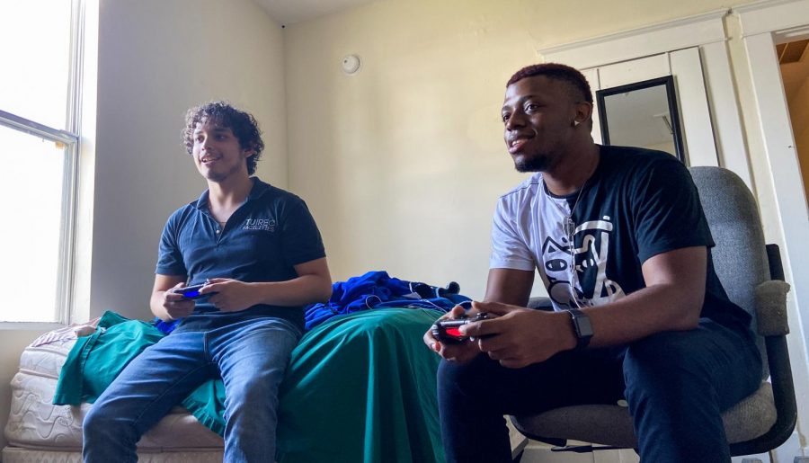 Musical theater junior Ryan Wiles plays video games in his apartment with his roommate Andres Paniagua. Wiles said that safe socializing and finding a sense of community through spending time with friends has helped him cope with the emotional strain of the COVID-19 pandemic. Photo courtesy of Ryan Wiles.