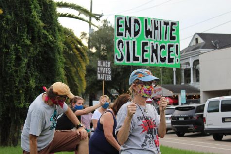 Joyce Thomas, the founder of Kneeling for 9 Minutes, protests.