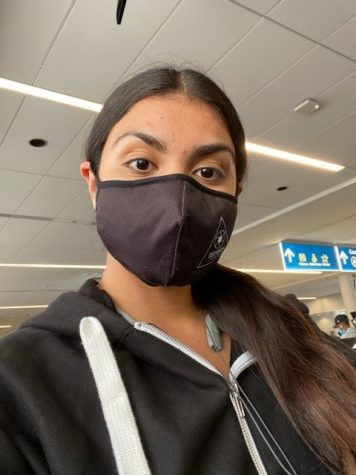 Rocio Valenzuela (pictured) wears a face mask in the Charlotte International Airport in North Carolina. All travelers are required to wear face coverings in the airport and on airplanes to reduce transmission of the COVID-19 virus.