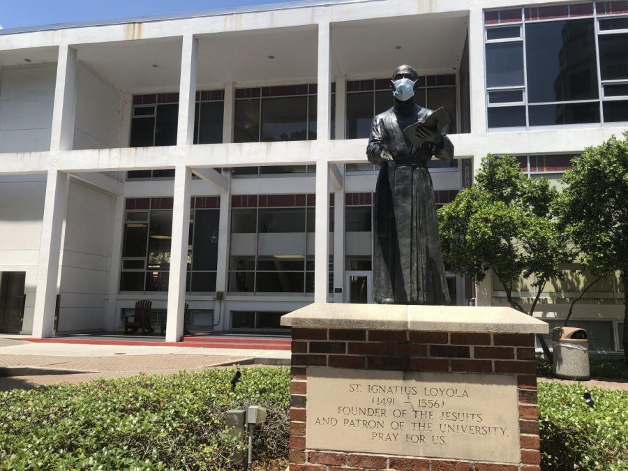 Loyolas statue of St. Ignatius stands outside of the Danna Center wearing a mask at the beginning of the Fall 2020 semester. 