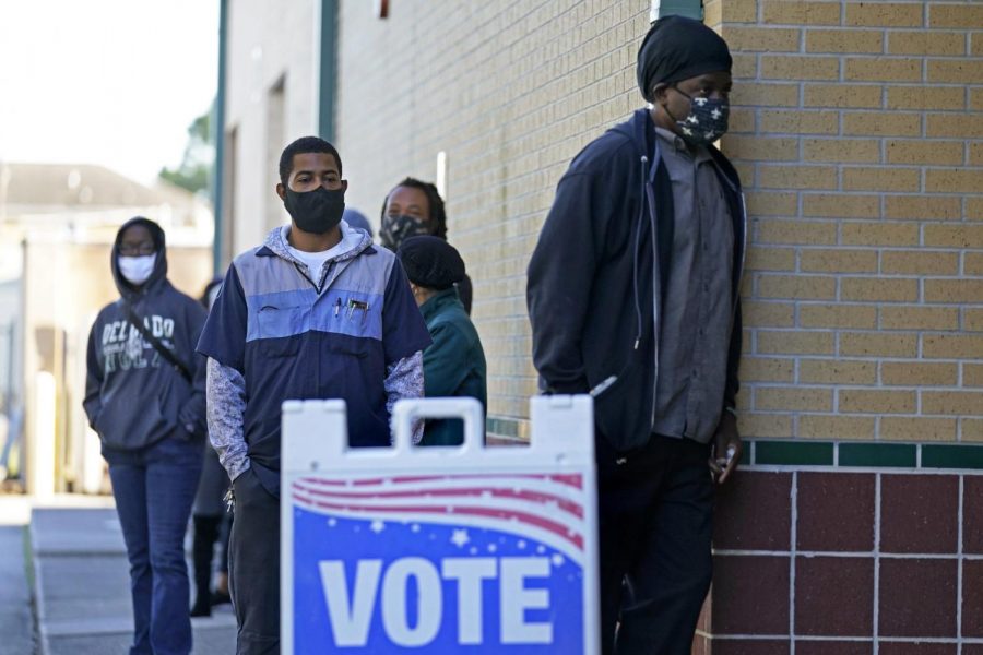 People line up to vote on Election Day at the Matin Luther King, Jr. Elementary School, in the Lower Ninth Ward of New Orleans, Tuesday, Nov. 3, 2020. (AP Photo/Gerald Herbert)
