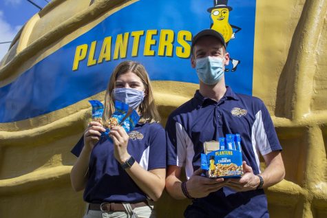 Peanutters Shannon Hope and Owen Luterbach stand in front of The NUTmobile, Friday, Feb. 26. The Peanutters have been in town since Feb. 24, handing out samples and volunteering at local businesses. 