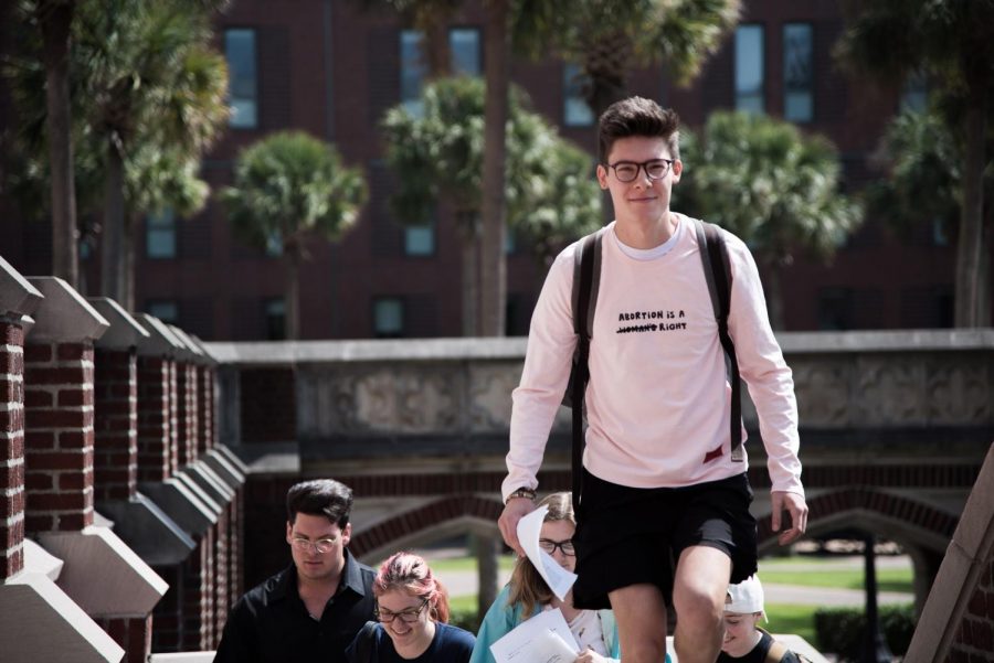 In this September 2019 file photo, members of student group Lxyno for Sexual Health march up the steps of Marquette Hall. Lxyno for Sexual Health, which is not officially affiliated with Loyola, advocates for access to sexual education and health resources on campus. Photo credit: Michael Bauer