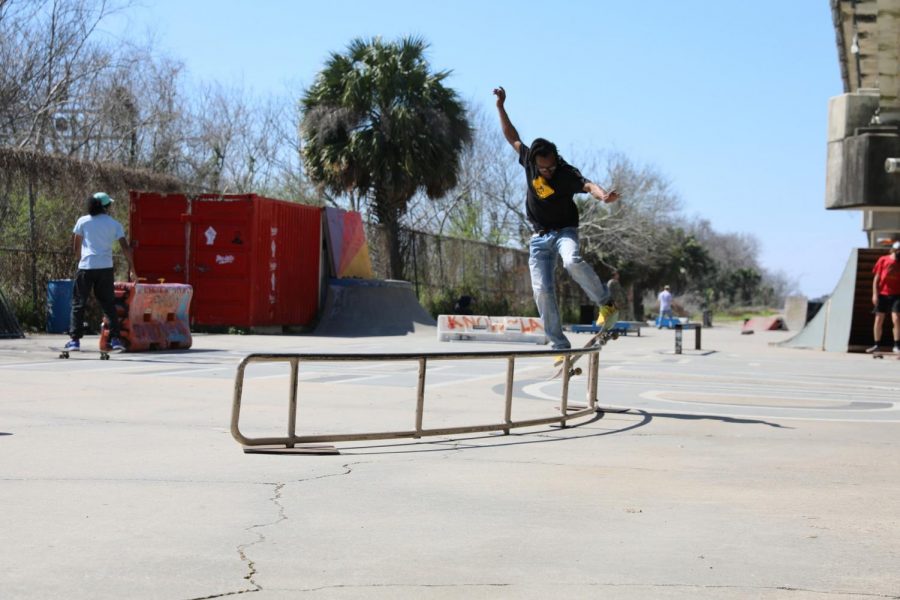 A skaterw grinds on a quarterpipeat a Parisite DIY Skatepark. Skateboarders find a community with others at places like this.