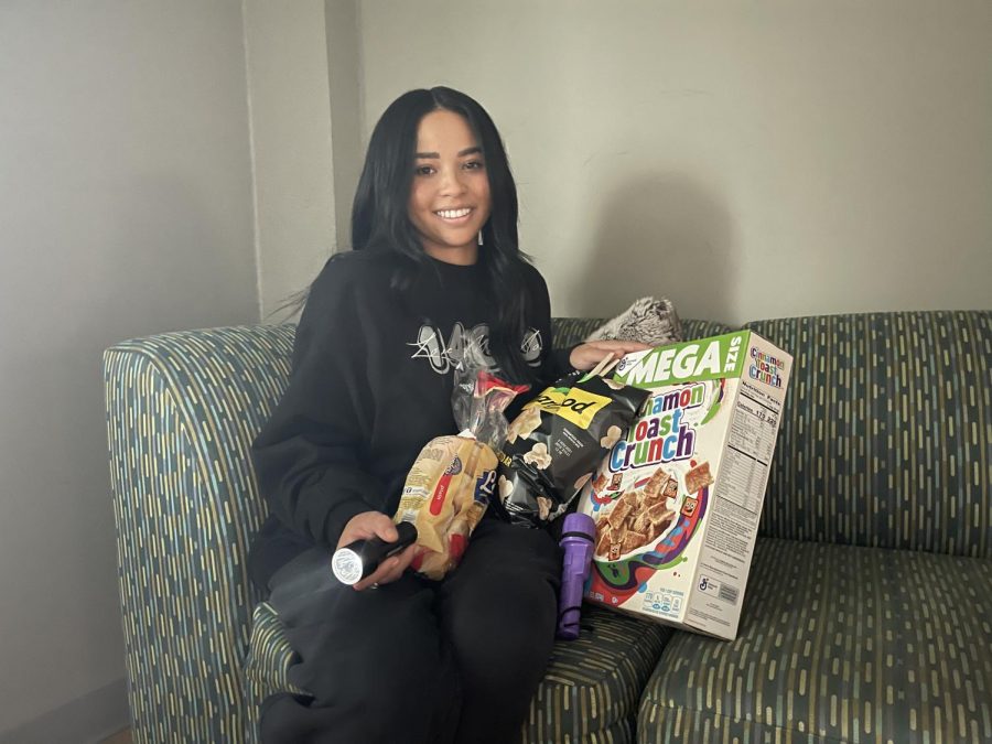 Finance sophomore Jordan Collins poses in her dorm with the supplies she purchased ahead of Hurricane Ida. Ida made landfall in Louisiana early Sunday afternoon.