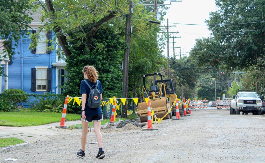 A+student+walks+through+a+roadwork+site+on+Freret+street%2C+Aug.+11%2C+2021.+The+roadwork%2C+which+is+expected+to+continue+through+September%2C+has+caused+Loyola+students+to+rethink+their+parking+plans.