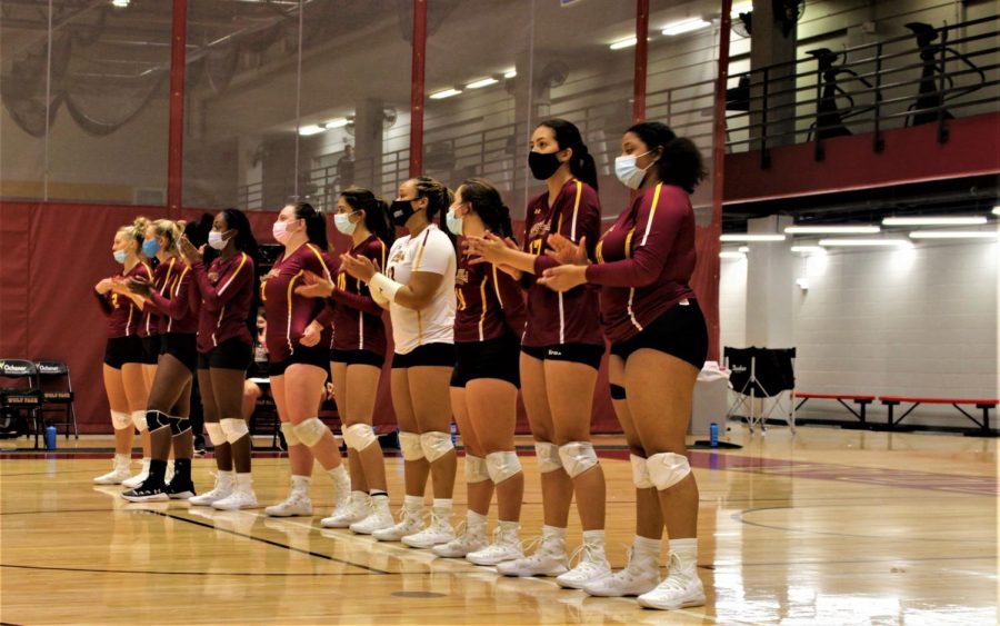 Members of the Loyola Volleyball team line up after a win.