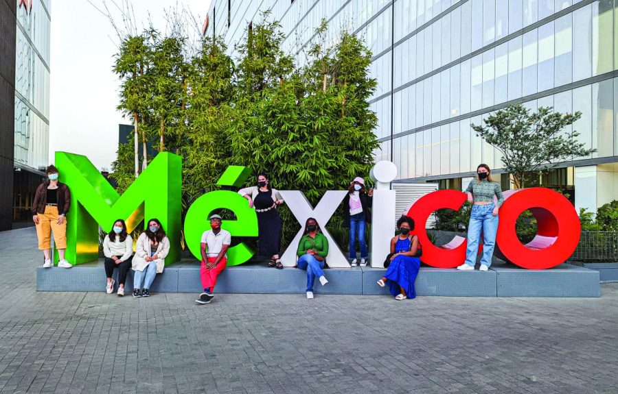 Kedrick Perry and study abroad students pose with a Mexico sign during their study abroad trip to Mexico in January 2021. Students studied abroad for free to learn about global social justice movements.  Courtesy of Kedrick Perry.
