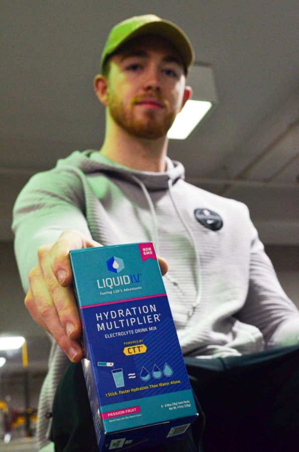 Luke Ladner holds up a box of powdered electrolyte mix which he is a brand ambassador for on Instagram.
